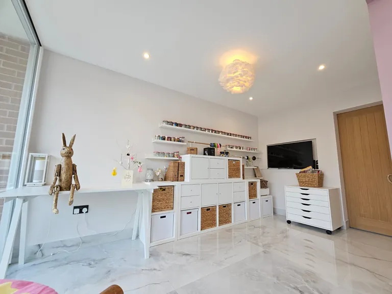White-painted room with shelving, storage and large windows